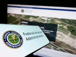 Cellphone with seal of US Federal Aviation Administration (FAA) on screen in front of website. Focus on center-left of phone display Cellphone with seal of US Federal Aviation Administration (FAA) on screen in front of website. Focus on center-left of phone display