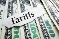 The word 'tariffs' atop spread out $100 U.S. bills. The word 'tariffs' atop spread out $100 U.S. bills.