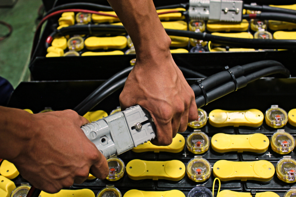 Battery being plugged in for an electric forklift. Photo by PS stock/Shutterstock.com