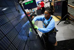 An installer works intently during the Solar Games competition at Intersolar in San Diego. An installer works intently during the Solar Games competition at Intersolar in San Diego.