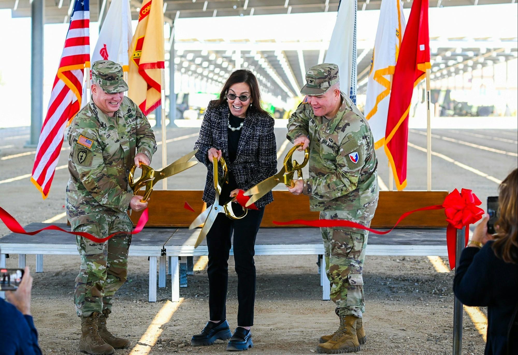 Brig. Gen. Christopher W. Cook, deputy commanding general of the 63rd Readiness Division; the Honorable Rachel Jacobson, assistant secretary of the Army for installations, energy and environment; and Col. Stephen Trotter, Fort Hunter Liggett Garrison Commander - cut the ceremonial ribbon to mark the completion of a $21.8 million microgrid project. (Photo Credit: U.S. Army photo by Augusta Vargas)