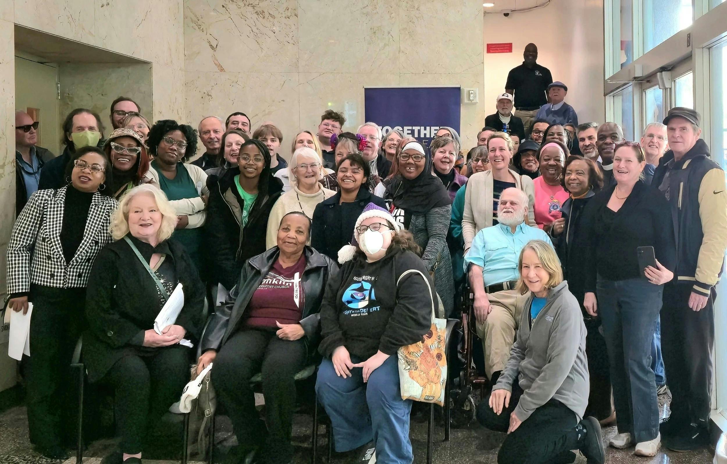 Supporters behind the Neighborhood Power Plan celebrate its passage by the New Orleans City Council earlier this month. Image credit Together Louisiana