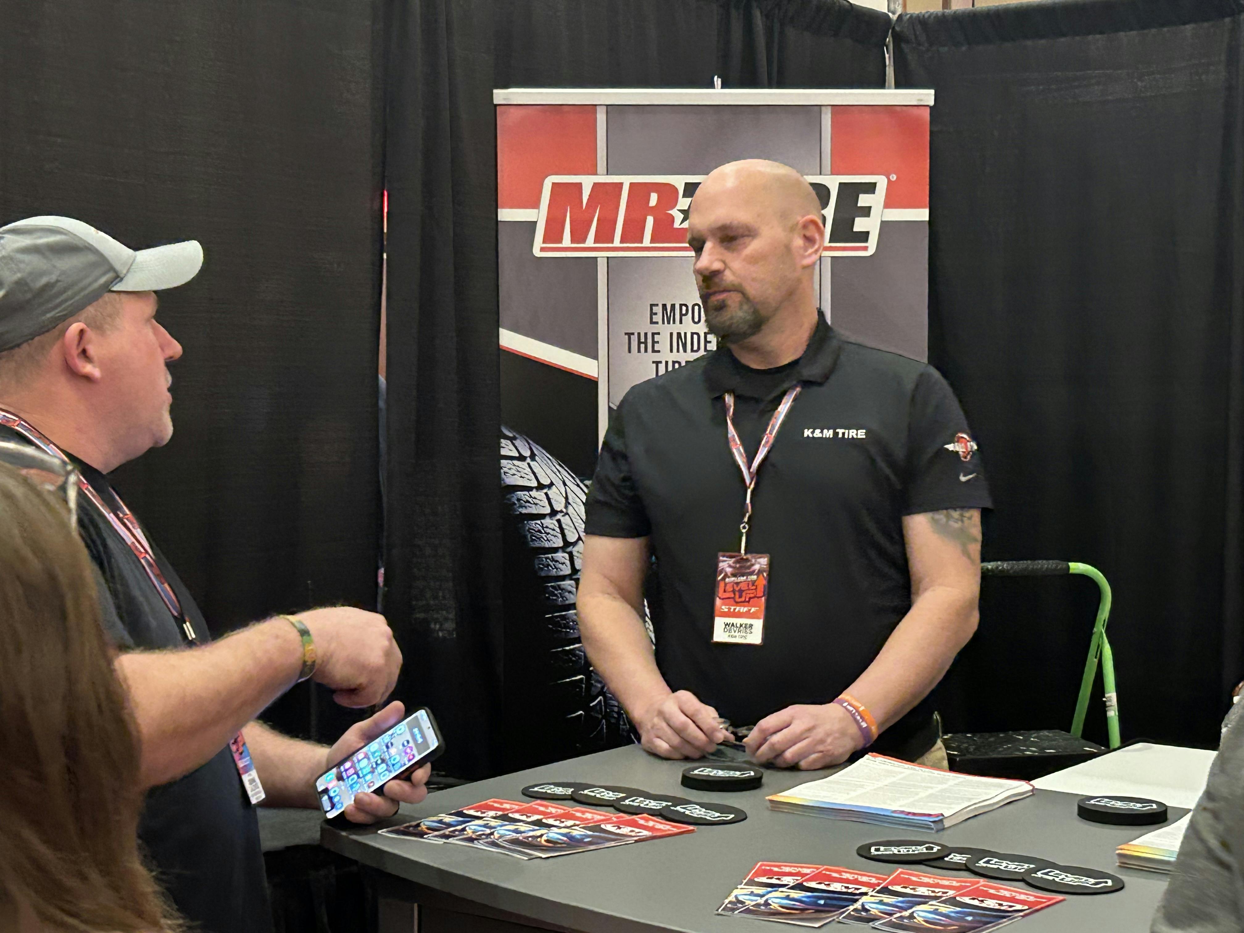 K&M Tire Inc.&rsquo;s Mr. Tire/Big 3 Tire is one of many groups that has expanded its offerings for dealer members. Here, a Mr. Tire/Big 3 Tire representative talks with dealers during K&M Tire&rsquo;s 2024 Dealer Conference and Trade Show.