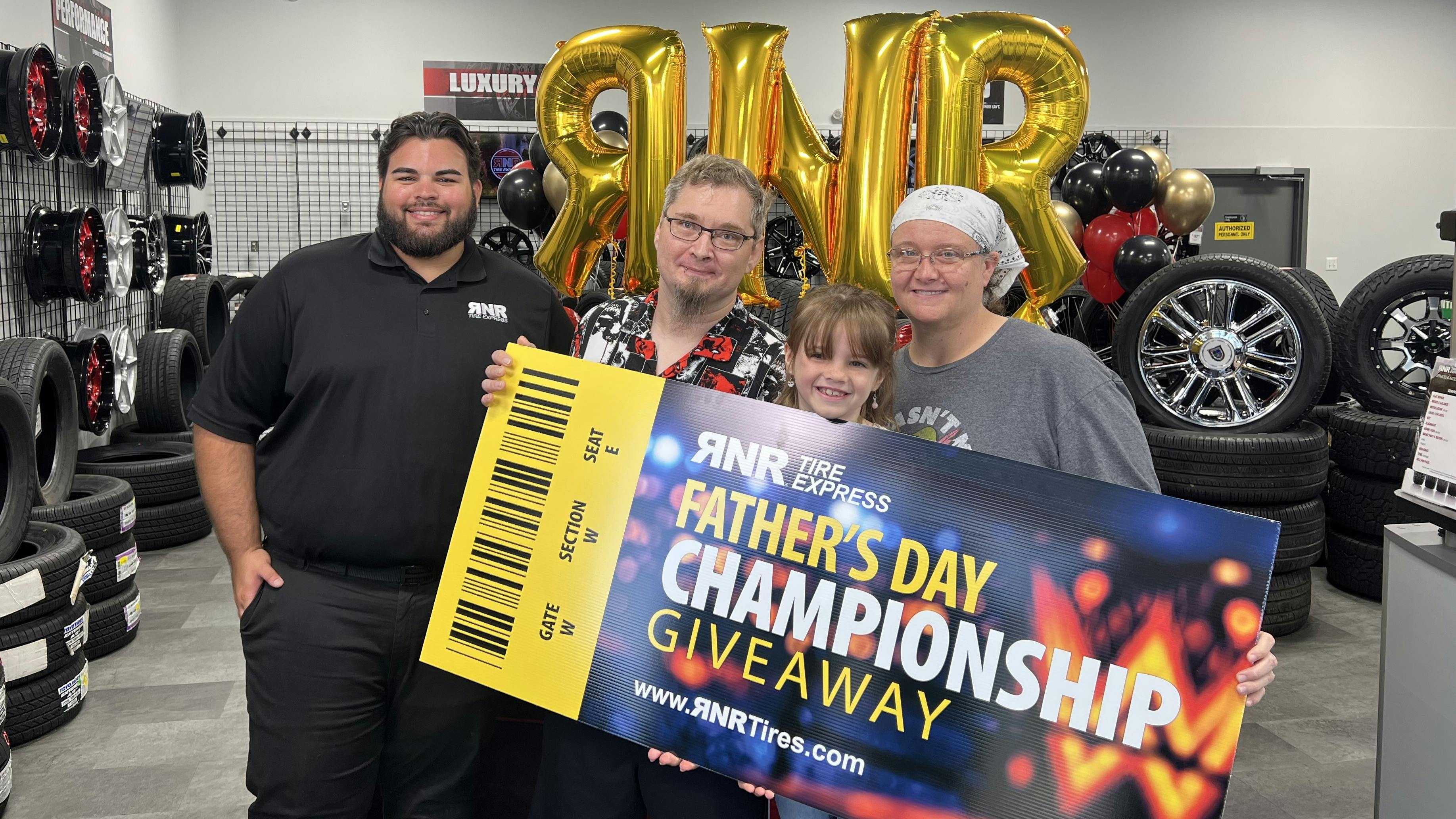 RNR Tire Express recently honored Ryan Loetscher (second from left) as part of its annual Father's Day Giveaway promotion.