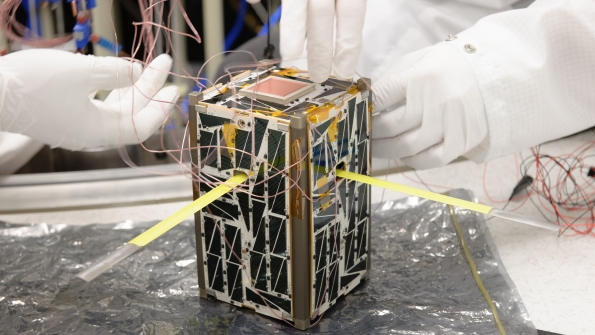 A tiny satellite being built as part of NASA39s Nodes project Engineers are preparing the satellite for thermal vacuum testing at Ames Research Center in California Image courtesy of NASA Ames