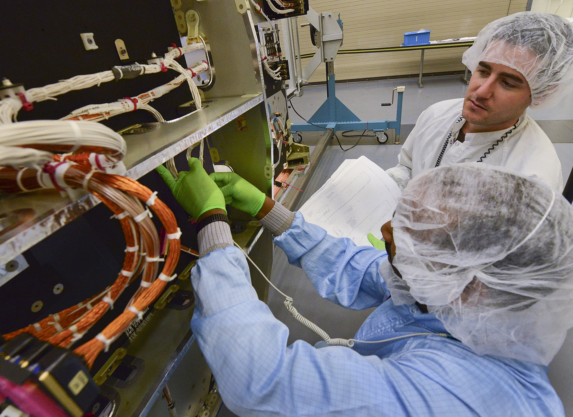 Northrop Grumman technicians in Redondo Beach California thread wiring and cabling through the fourth protected communications payload for the US Air Force39s Advanced Extremely High Frequency satellite system photo courtesy of Northrop Grumman
