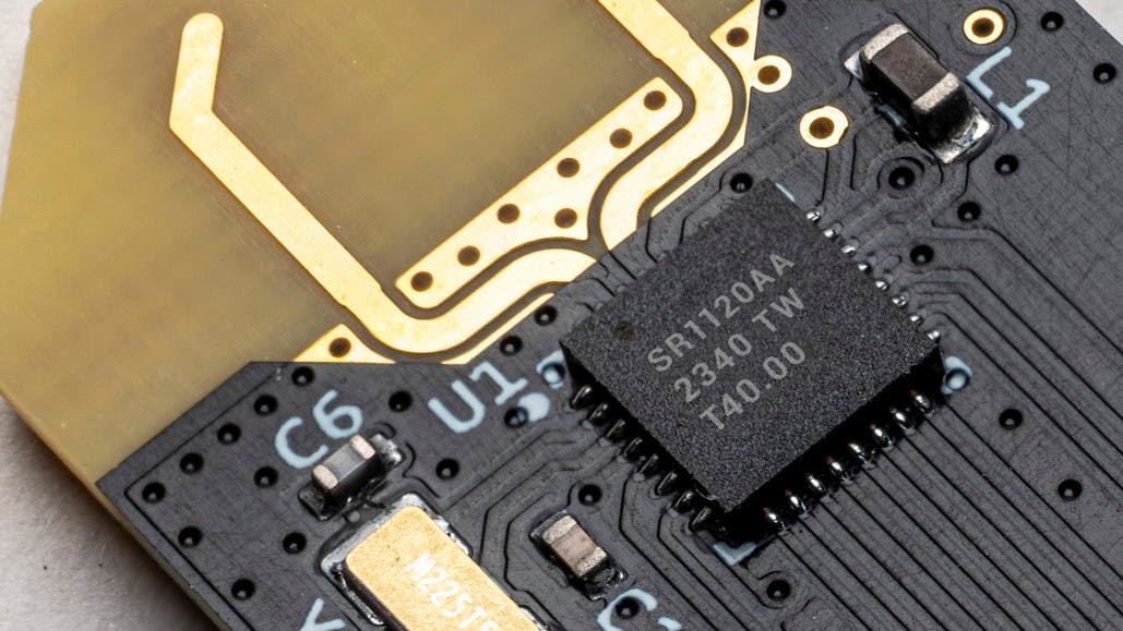 A Spark Microsystems SR1120 UWB transceiver chip is mounted on a printed-circuit board