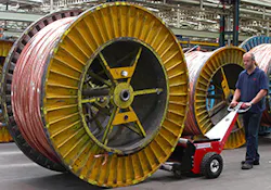 Worker Pushing a 9-ton Cable Drum Worker Pushing a 9-ton Cable Drum