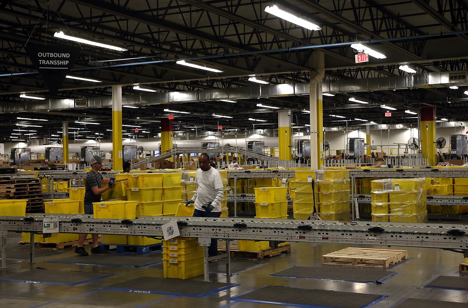 Workers-Packing-Yellow-Bins-In-Factory