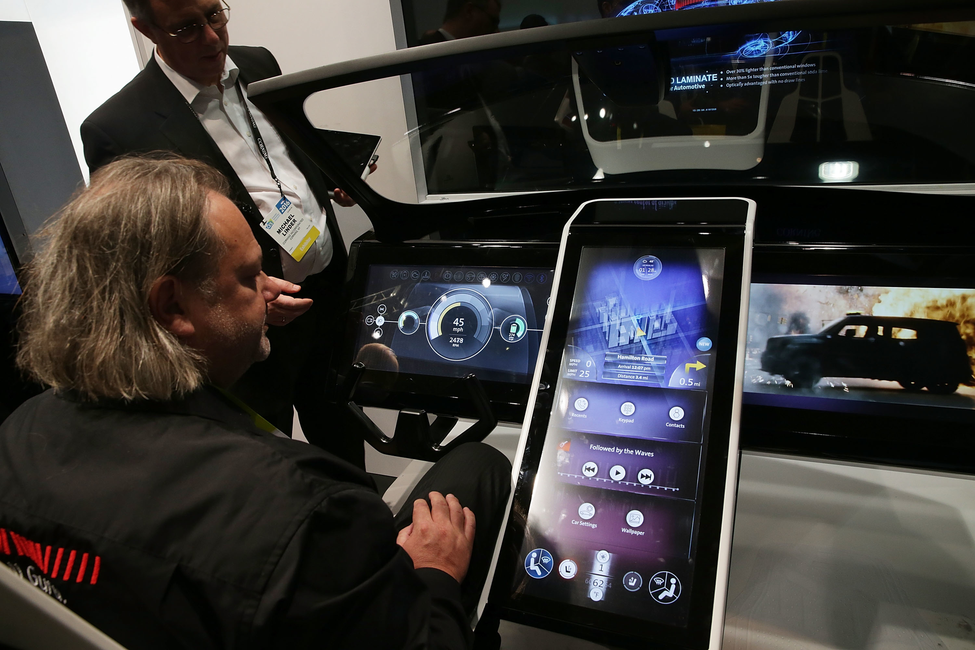 Man inspects connected car console on display