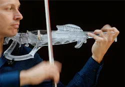 Man playing 3D printed violin Man playing 3D printed violin