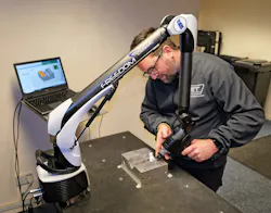 Ryan Leaves, who looks after inspection at GT Tooling, using the FREEDOM Classic Scan portable arm to inspect part of an aluminum extrusion blow mold for plastic bottle production. Ryan Leaves, who looks after inspection at GT Tooling, using the FREEDOM Classic Scan portable arm to inspect part of an aluminum extrusion blow mold for plastic bottle production.