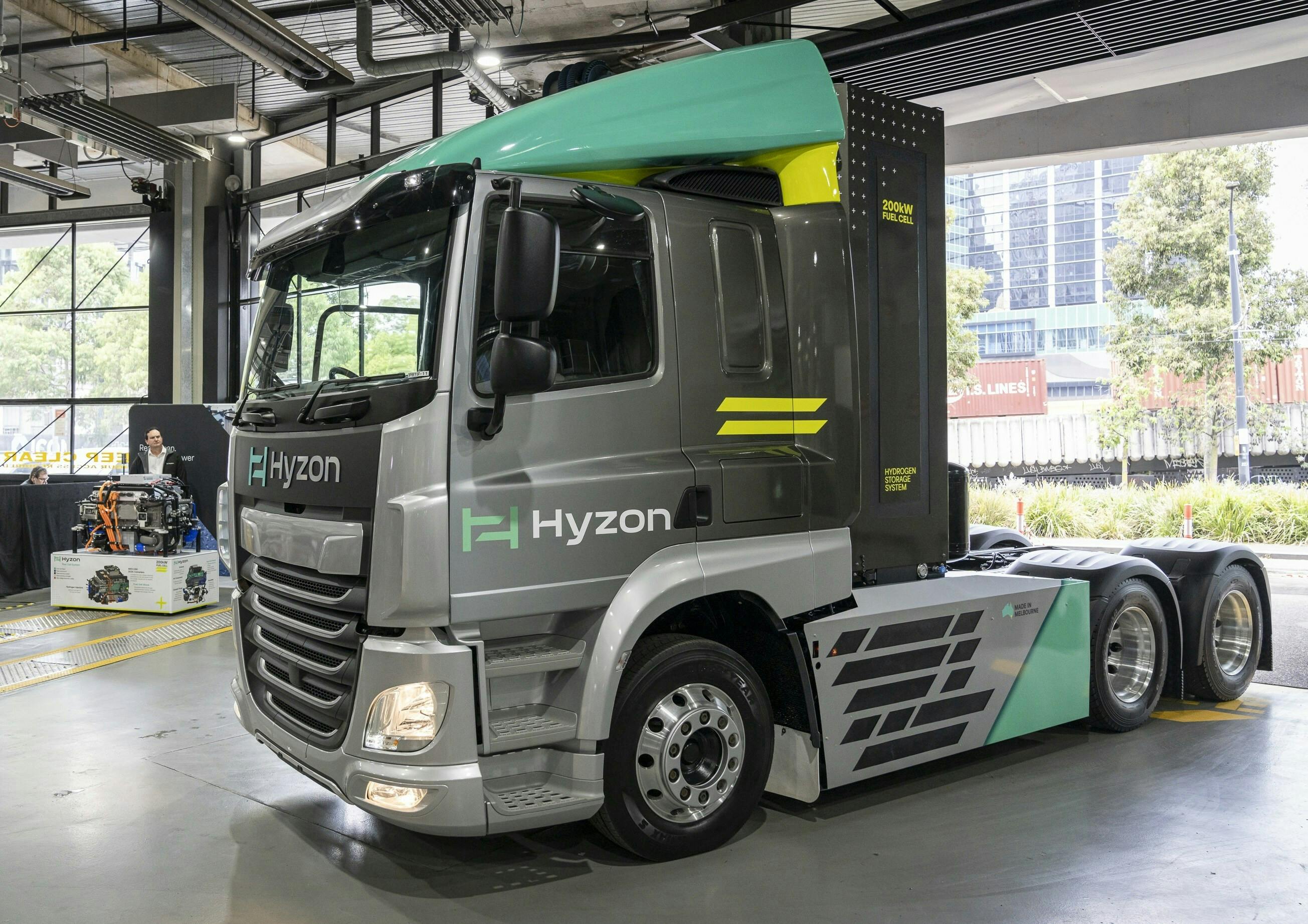 Hyzon&rsquo;s Prime Mover in the foreground with John Edgley, Managing Director, Hyzon Australia standing by the newly introduced single stack 200kW fuel cell system, which powers the vehicle.
