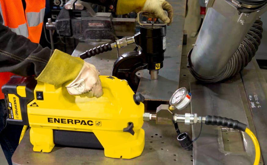 Punching holes using the Enerpac SC-Series portable hydraulic pump.