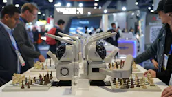SenseRobot's Chess robot on display with CES attendess interacting and playing chess with them at a table. SenseRobot's Chess robot on display with CES attendess interacting and playing chess with them at a table.