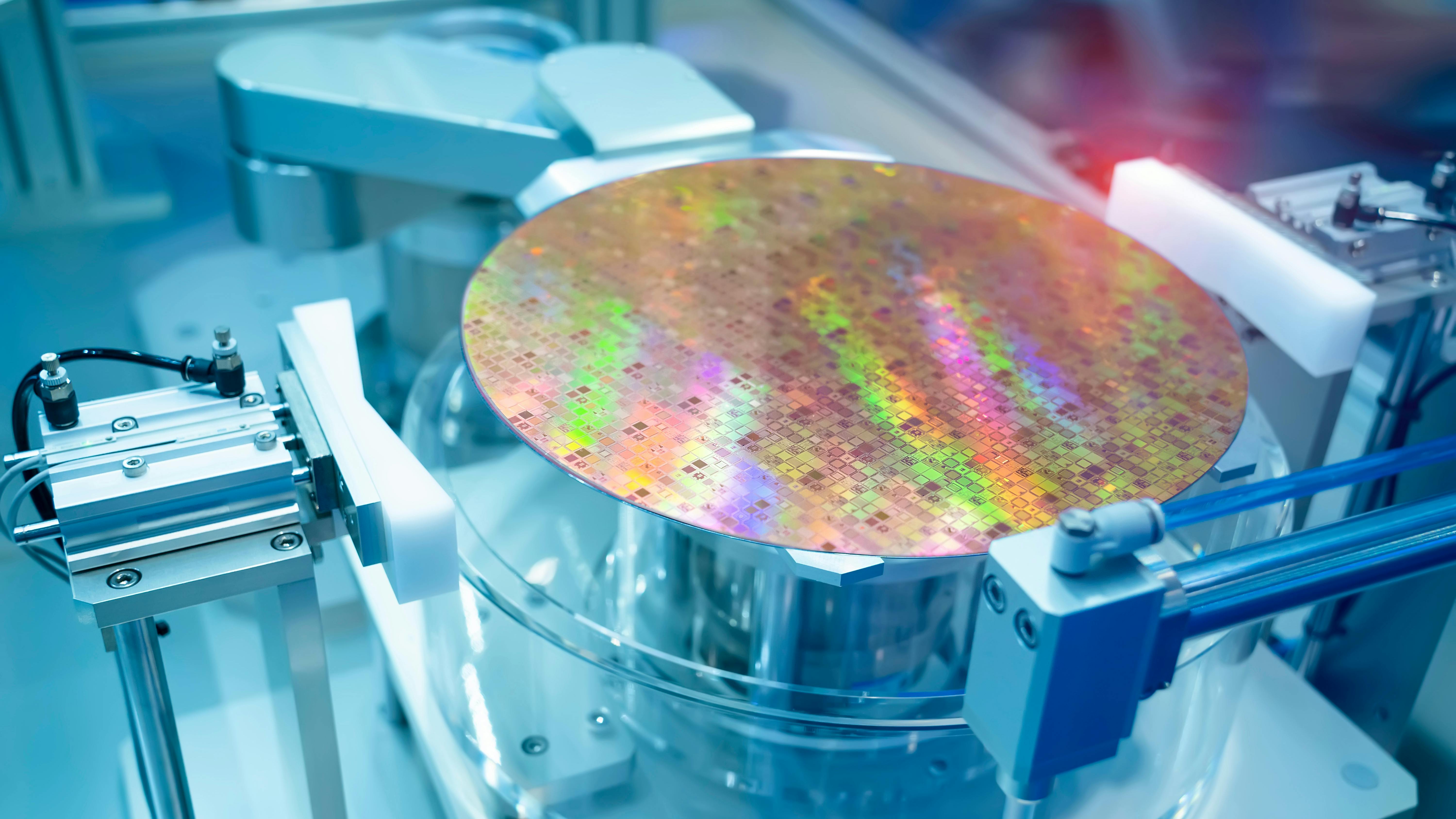 A silicon wafer being examined in a manufacturing lab.