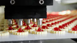Jam cookies being produced in a factory on an assembly line. Jam cookies being produced in a factory on an assembly line.