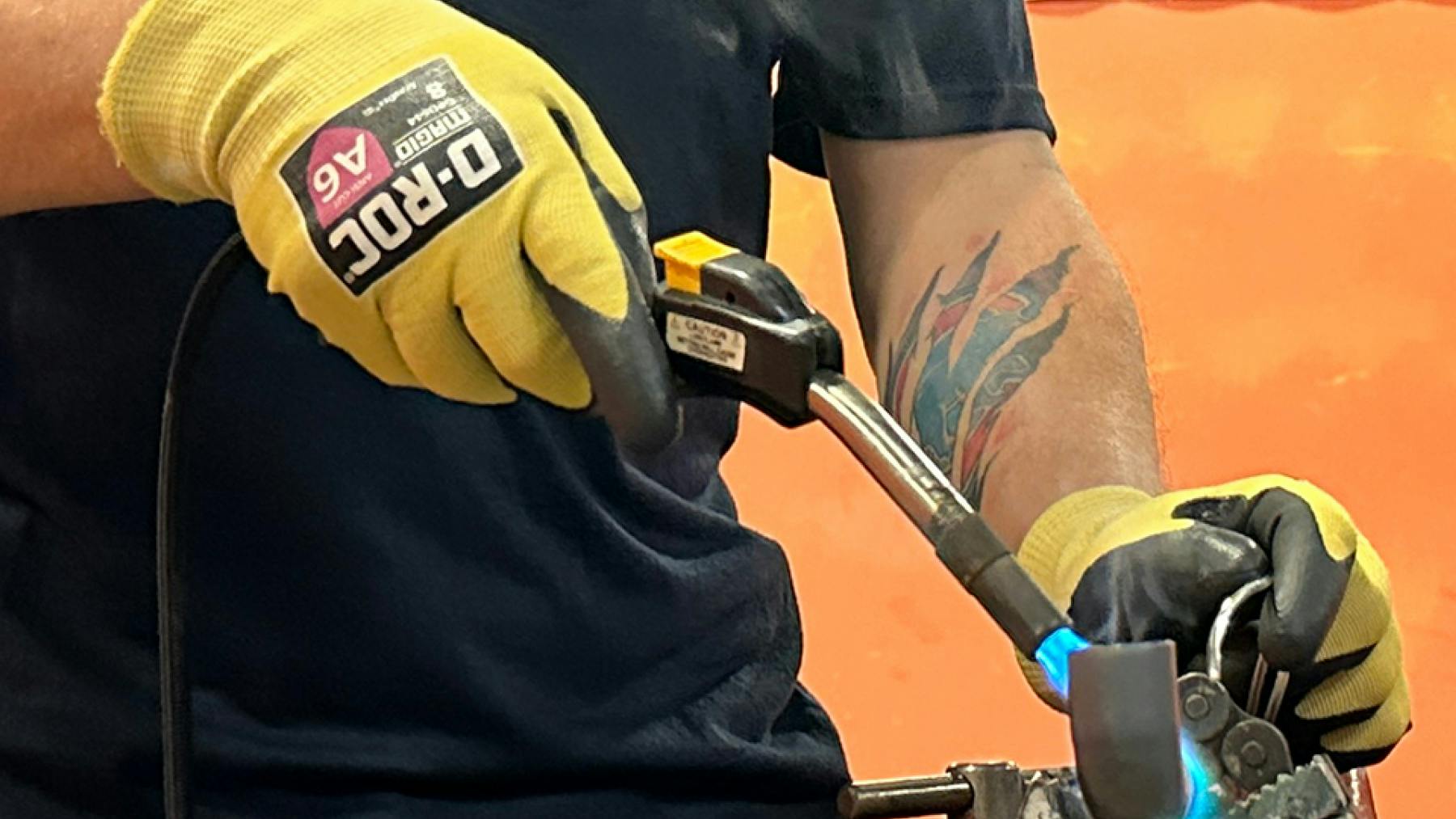 Magid AeroDex FR gloves worn on worker using welding tool