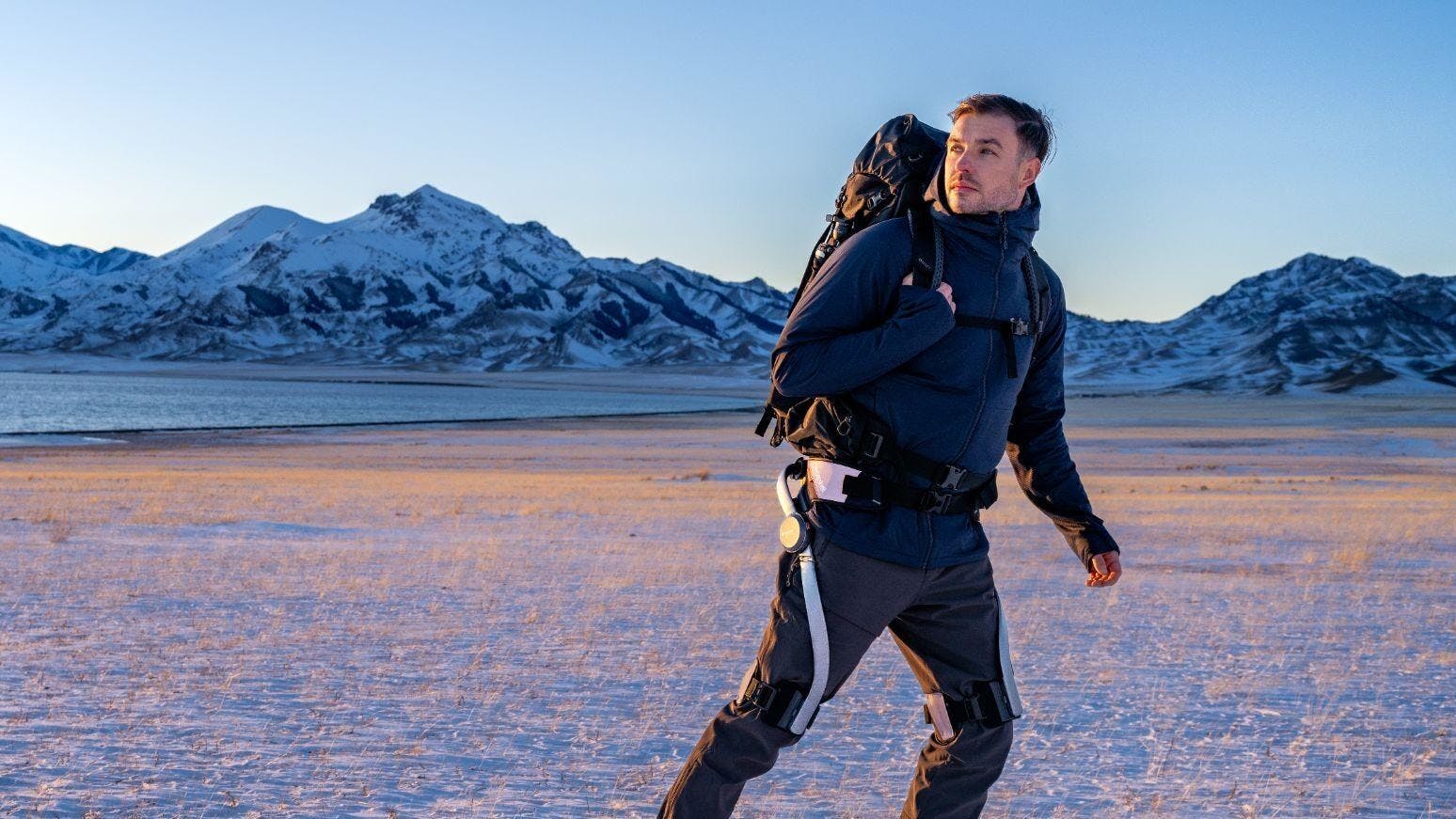 Hypershell X Series PowerSuit exoskeleton for outdoor adventures being worn by a man hiking in the mountains.