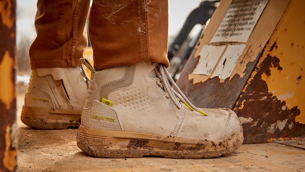 Close-up of Grey Xtend Safety Boots being worn in outdoor, dusty environment.