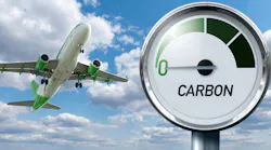 Gauge with inscription CARBON and arrow points to zero on a background of plane in sky. Gauge with inscription CARBON and arrow points to zero on a background of plane in sky.