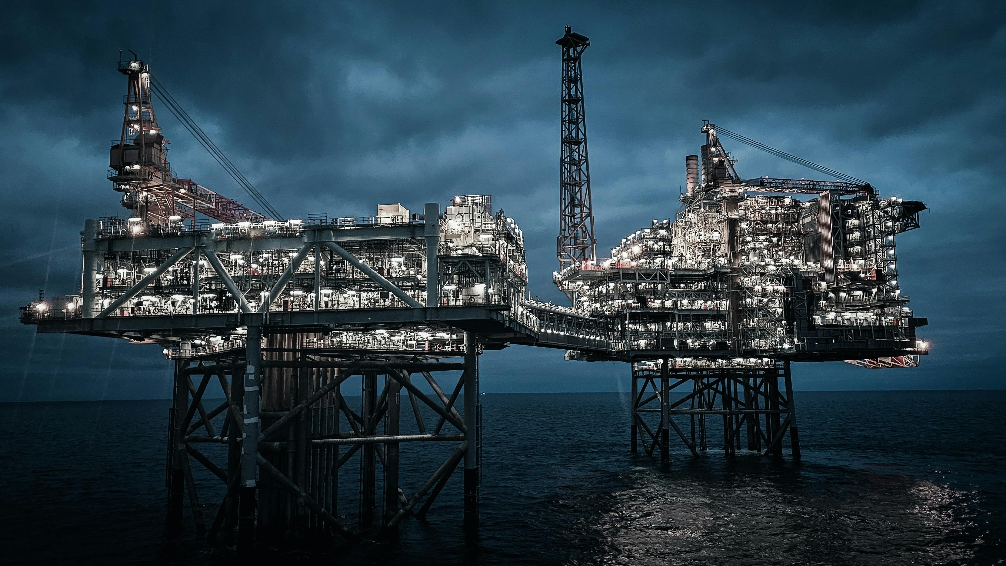 Offshore oil and gas platform at night