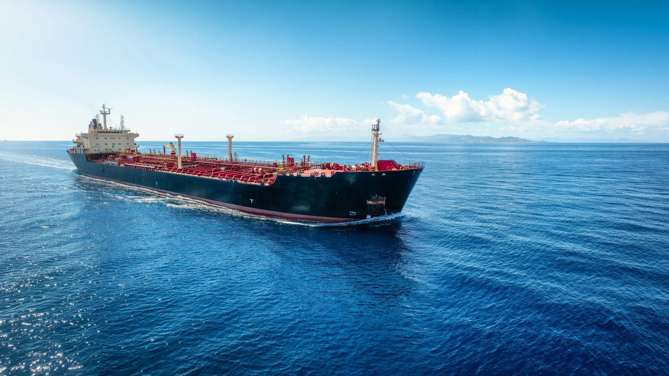 Aerial view of a heavy crude oil tanker traveling with speed over the ocean