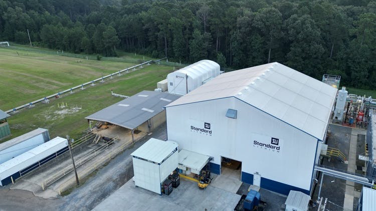 Aerial view of Standard Lithium demonstration plant on plot of land with trees in background