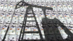 oil equipment shadow on US currency background oil equipment shadow on US currency background