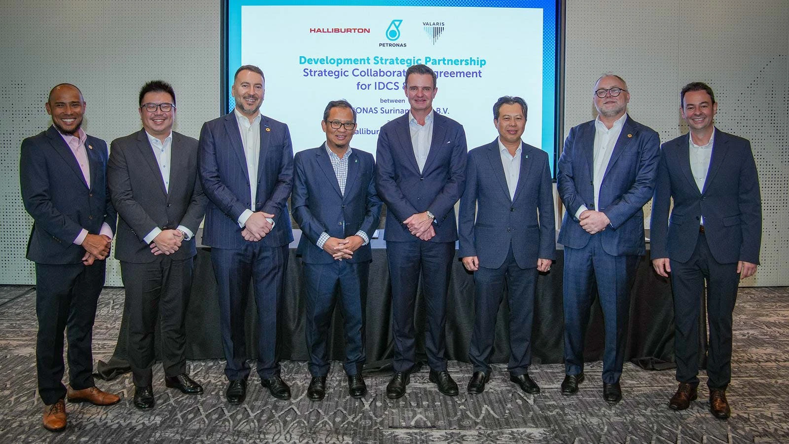 Men from Petronas, Valaris, and Halliburton stand together following signing of an agreement