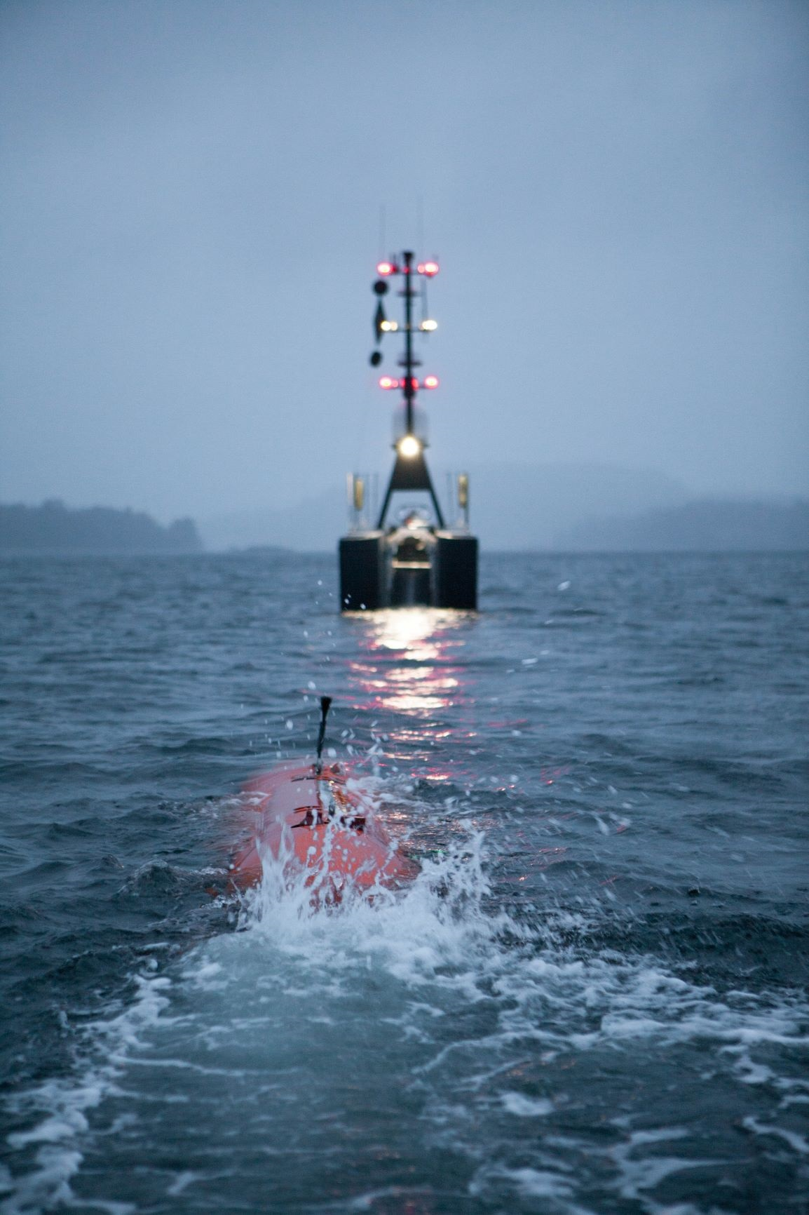 An AUV being recovered into a SEA-KIT uncrewed surface vessel.