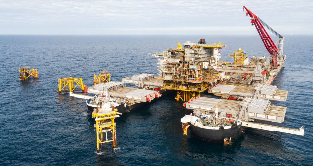 The Pioneering Spirit with the 7,800-metric ton (8,598-ton) Tyra West Alpha processing platform topsides.