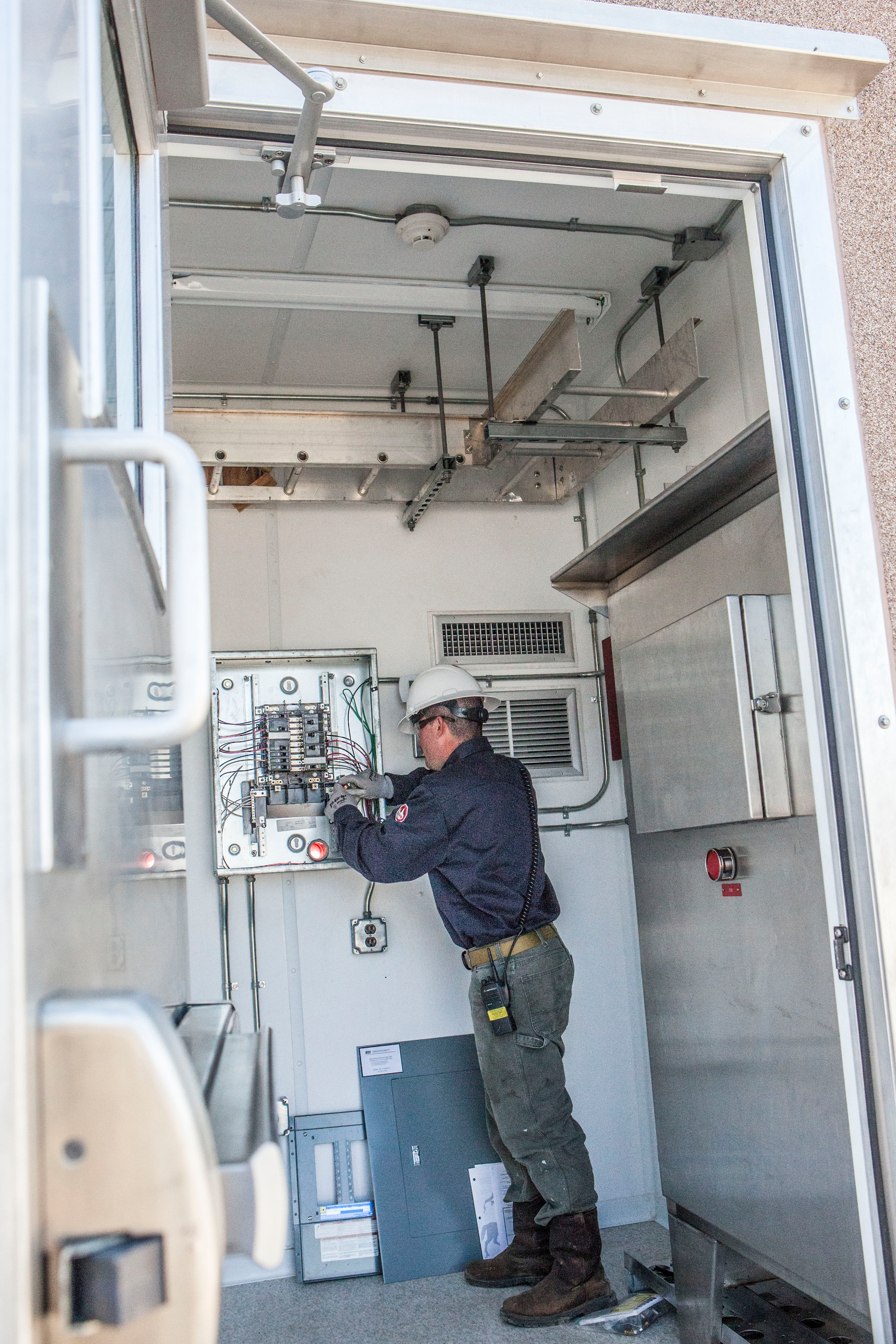 An employee performs onshore instrumentation and electrical work.