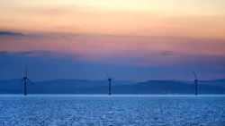 Offshore wind turbines operate at sunset off the Irish coast. Offshore wind turbines operate at sunset off the Irish coast.