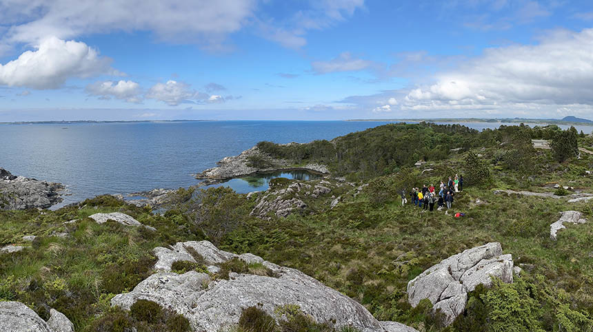 Holns&oslash;y seascape in June 2023: HNET consortium members gather around a geophone station that is part of the HNAR onshore array monitoring the subsurface microseismic activity in the future CO2 storage area.
