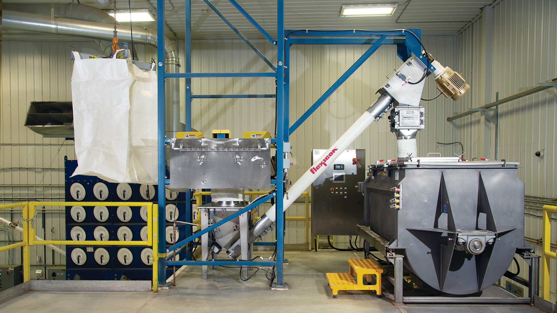 The BFC model bulk bag discharger, equipped with cantilevered I-beam, hoist and trolley, lifts the bulk bag from the level below. The bulk bag discharger and flexible screw conveyor gently feed the blender which mixes protein powder and other ingredients.