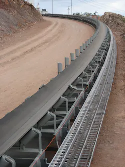 This overland belt conveyor is curved to follow the terrain. This overland belt conveyor is curved to follow the terrain.