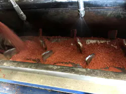 Interior view of a pugmill mixer (with binder spray system) during testing in the FEECO Innovation Center. Interior view of a pugmill mixer (with binder spray system) during testing in the FEECO Innovation Center.