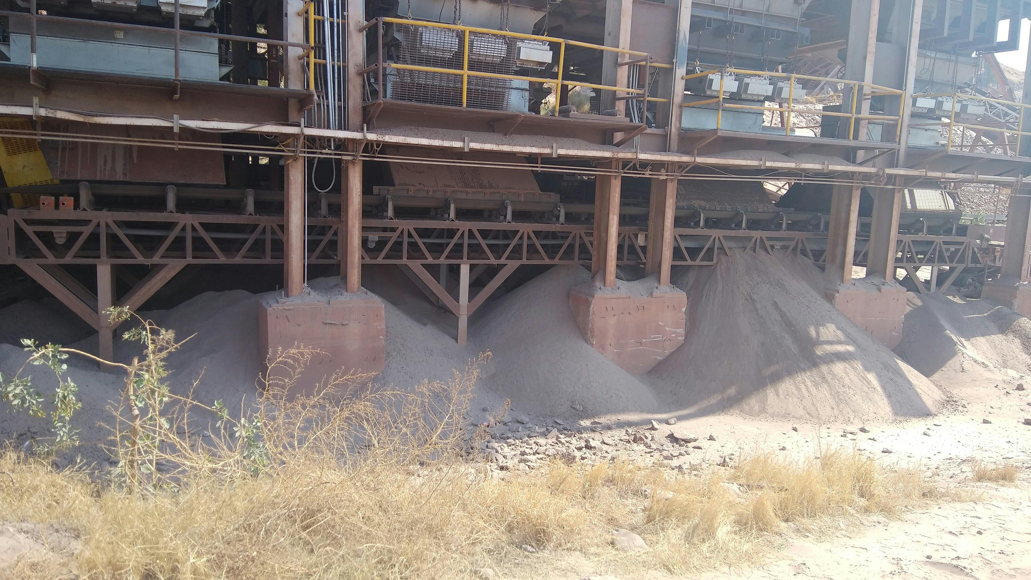 Fugitive material accumulating beneath a belt conveyor