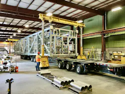 A horizontal-built truckable module being loaded indoors for transportation to the final project. A horizontal-built truckable module being loaded indoors for transportation to the final project.