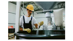 Worker monitoring a mixing process Worker monitoring a mixing process