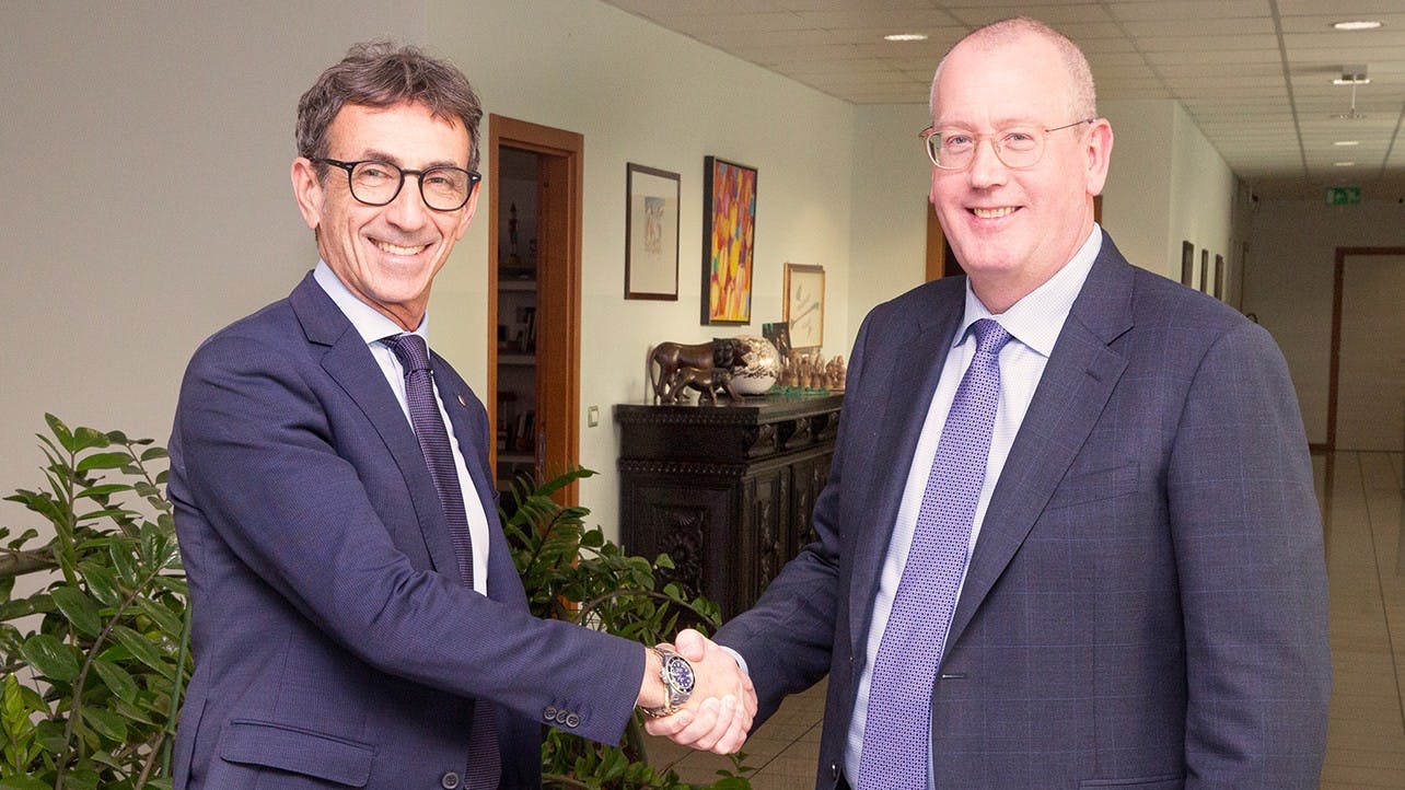 Valerio Soli (left) of Marchesini Group and AST CEO Joe Hoff shake hands during partnership agreement