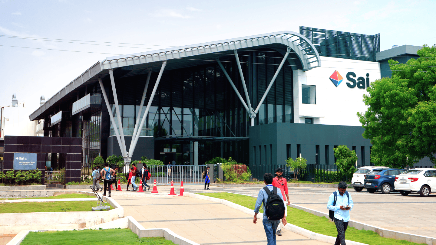 Workers walking outside to and from Sai Life Sciences building in Hyderabad, India