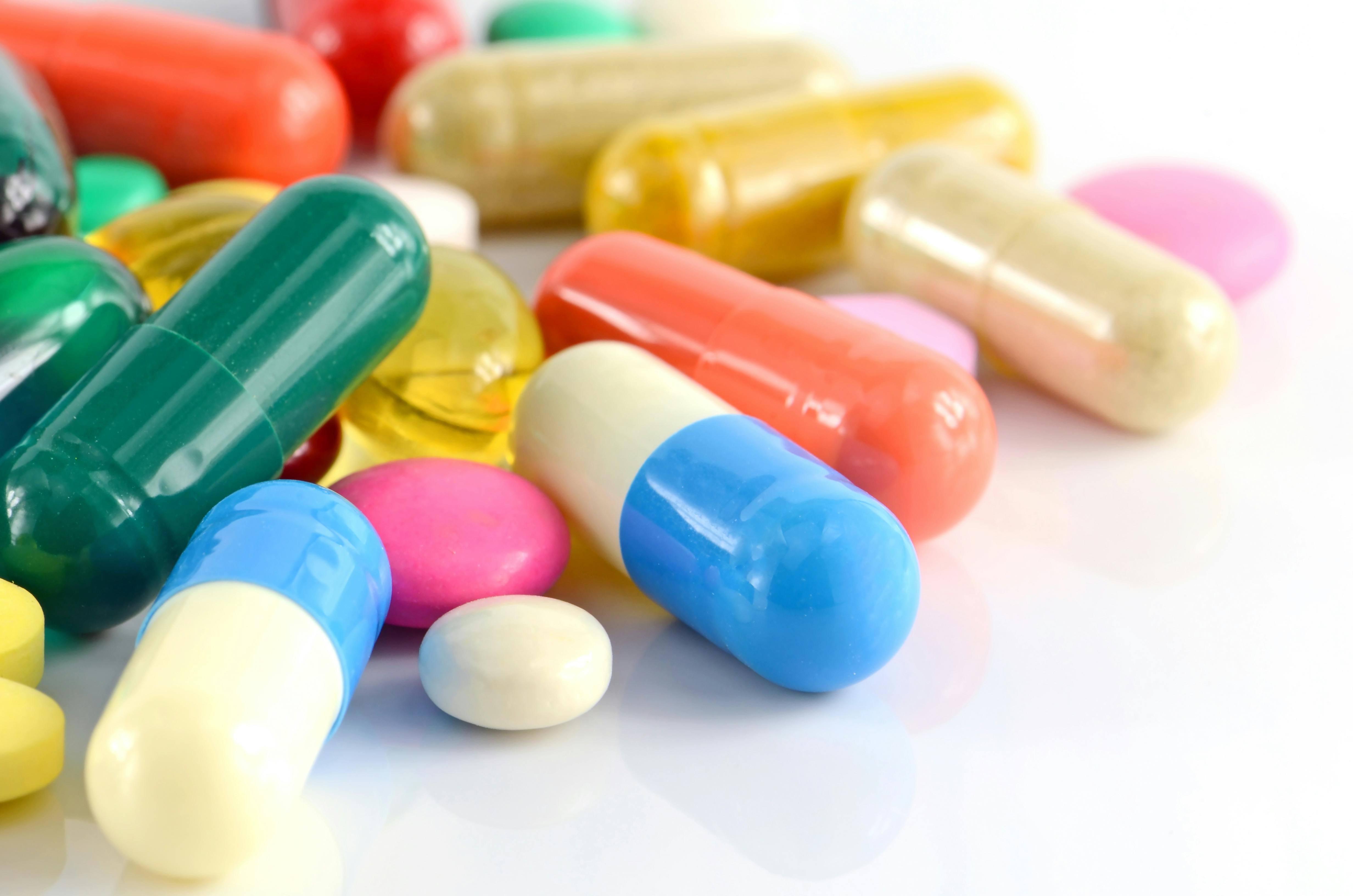 Colorful closeup of oral medications on White Background.