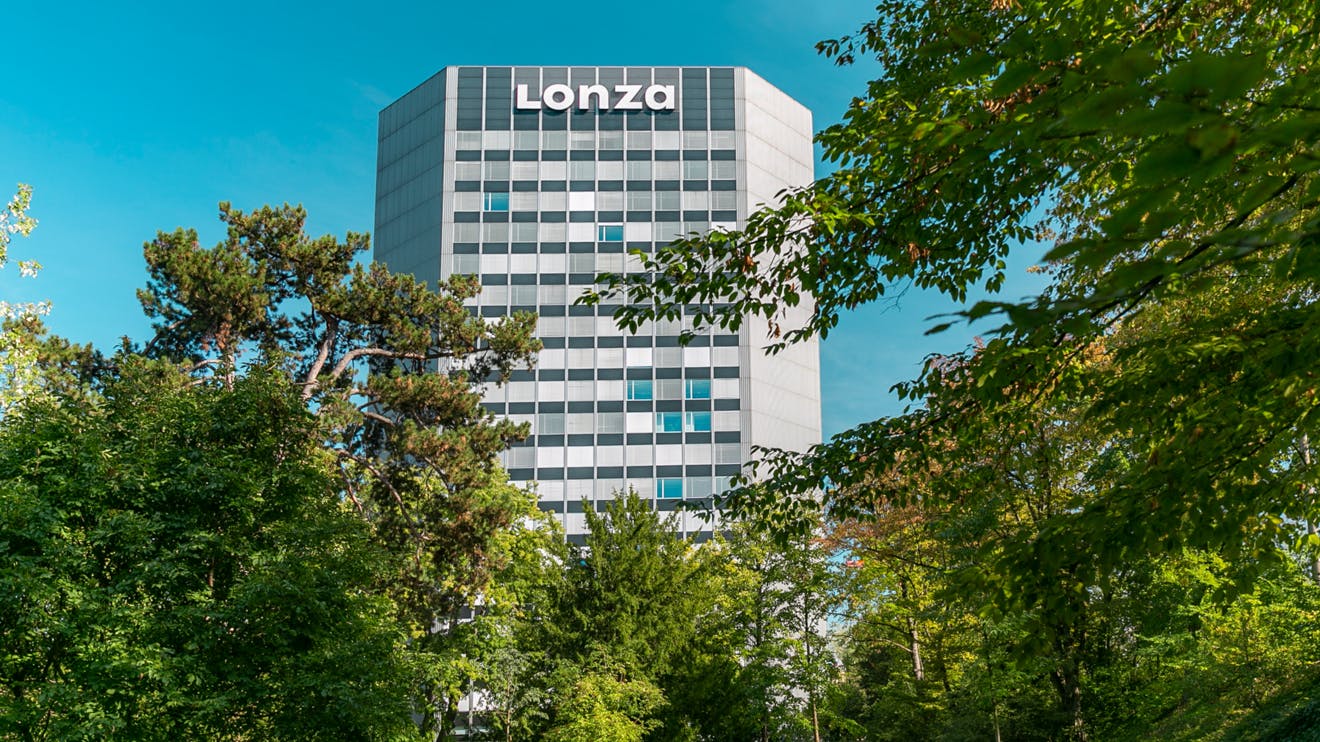 View through the trees of Lonza corporate headquarters building in Switzerland