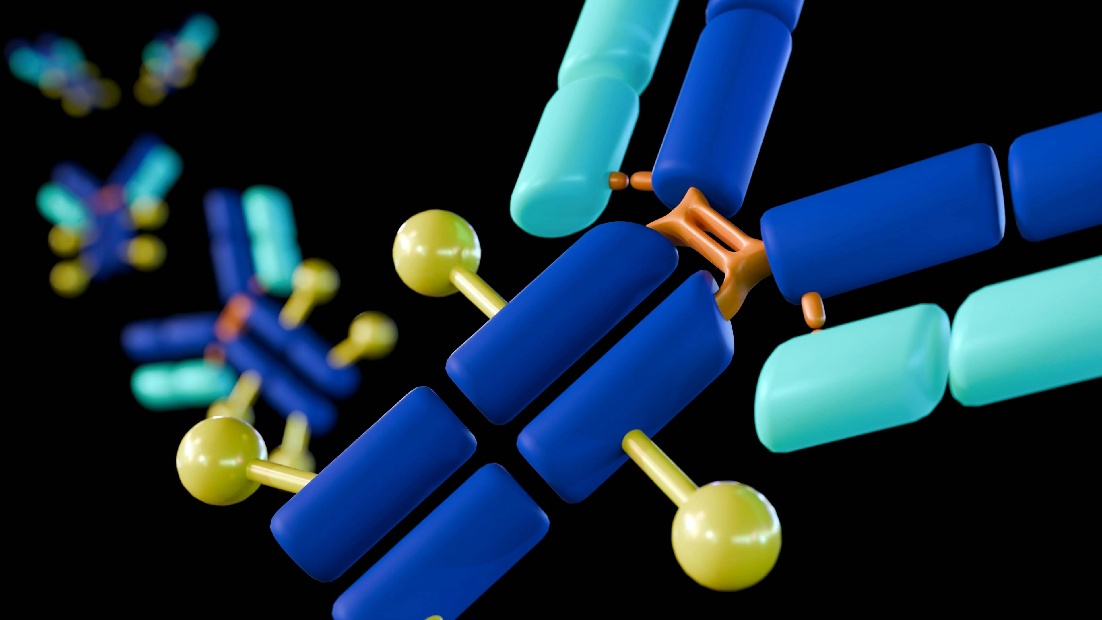 A 3d rendered image displays multiple Y-shaped antibody molecules. They are depicted in blue and light blue segments connected by orange and yellow parts, illustrating antibody-drug conjugates (ADCs).