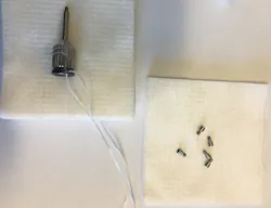 Figure 1: Implant driver ligated with floss and new prosthetic screws Figure 1: Implant driver ligated with floss and new prosthetic screws