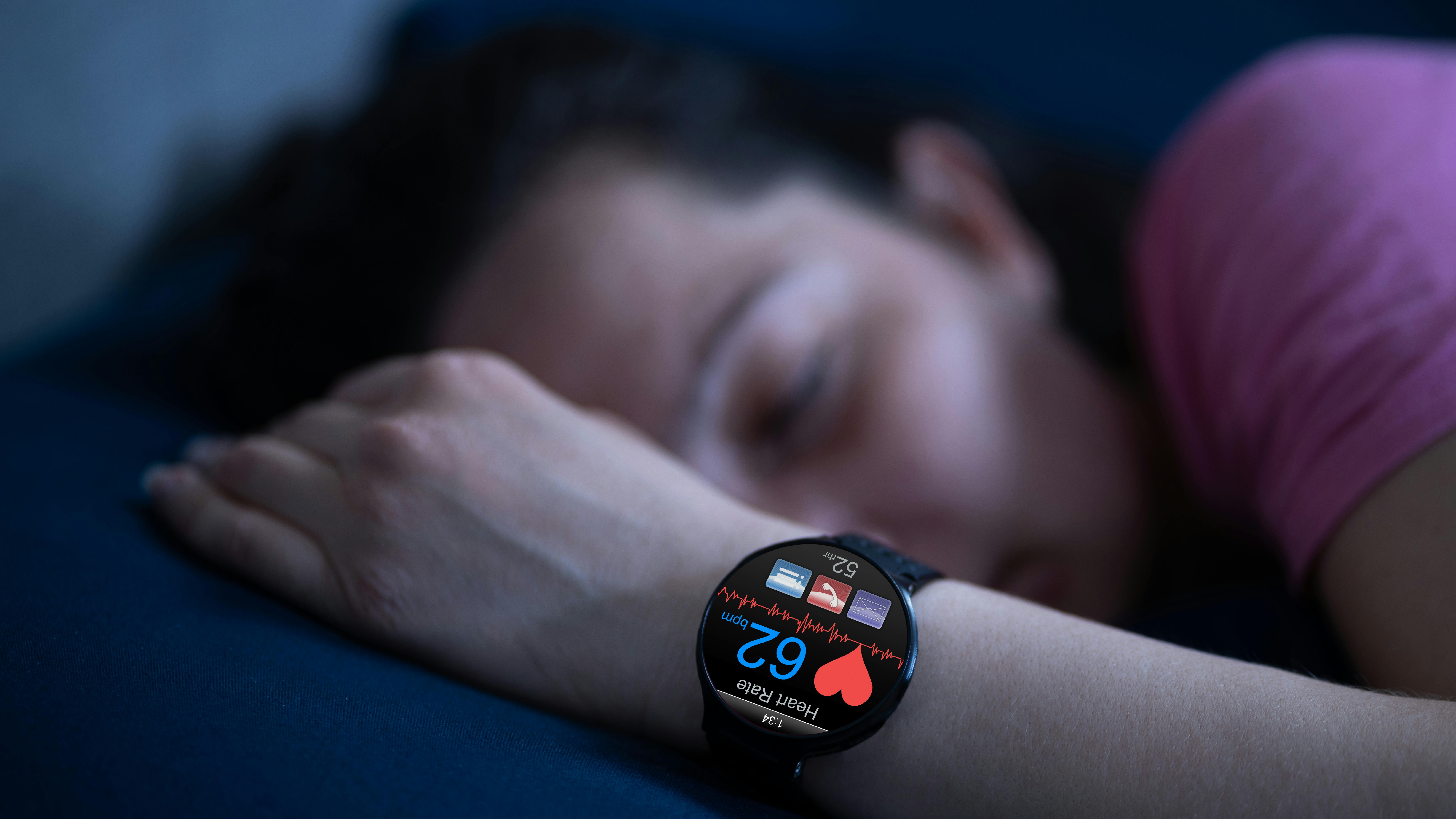 woman sleeping with a wearable sleep watch