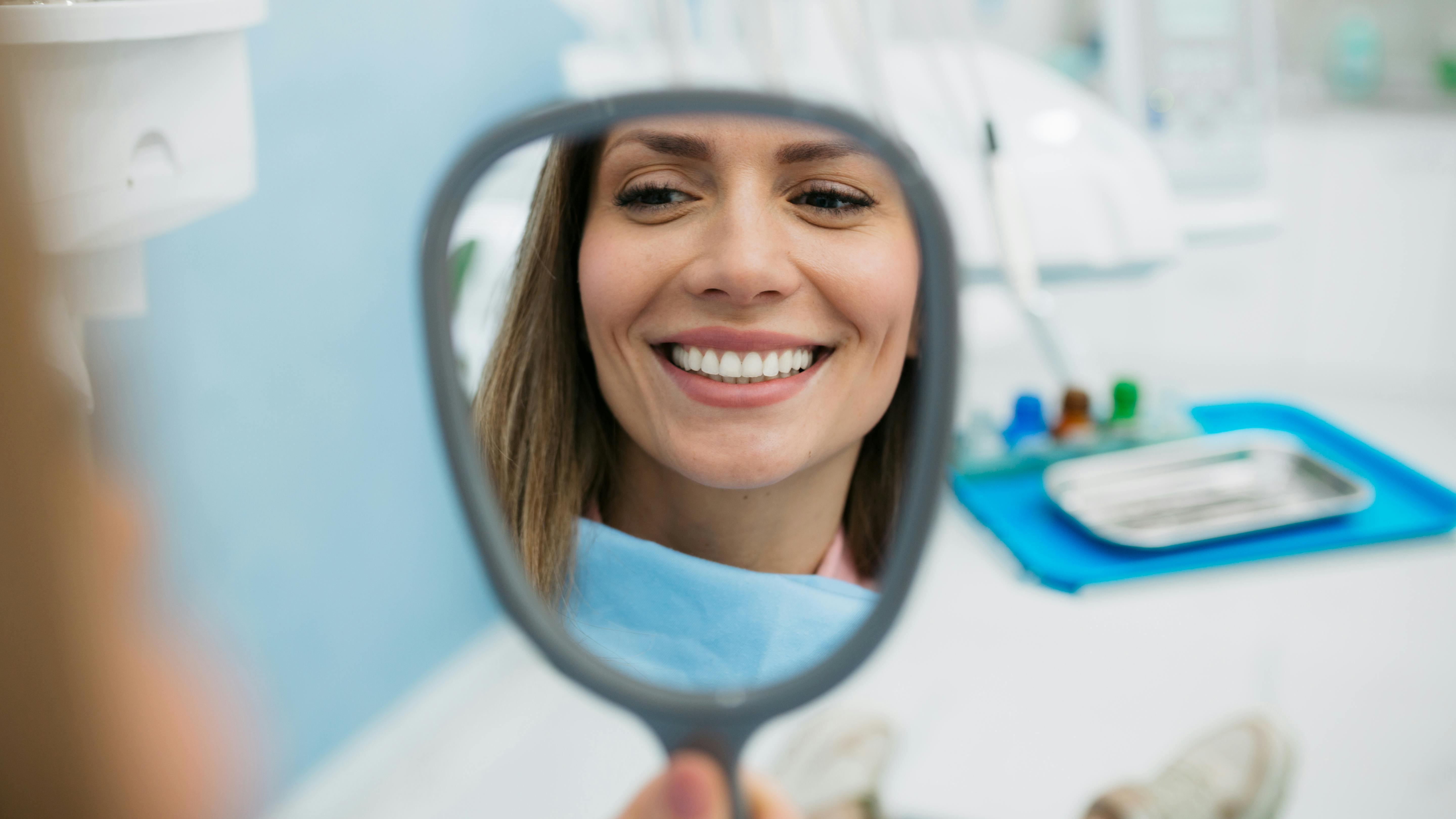 smiling woman looking in a mirror