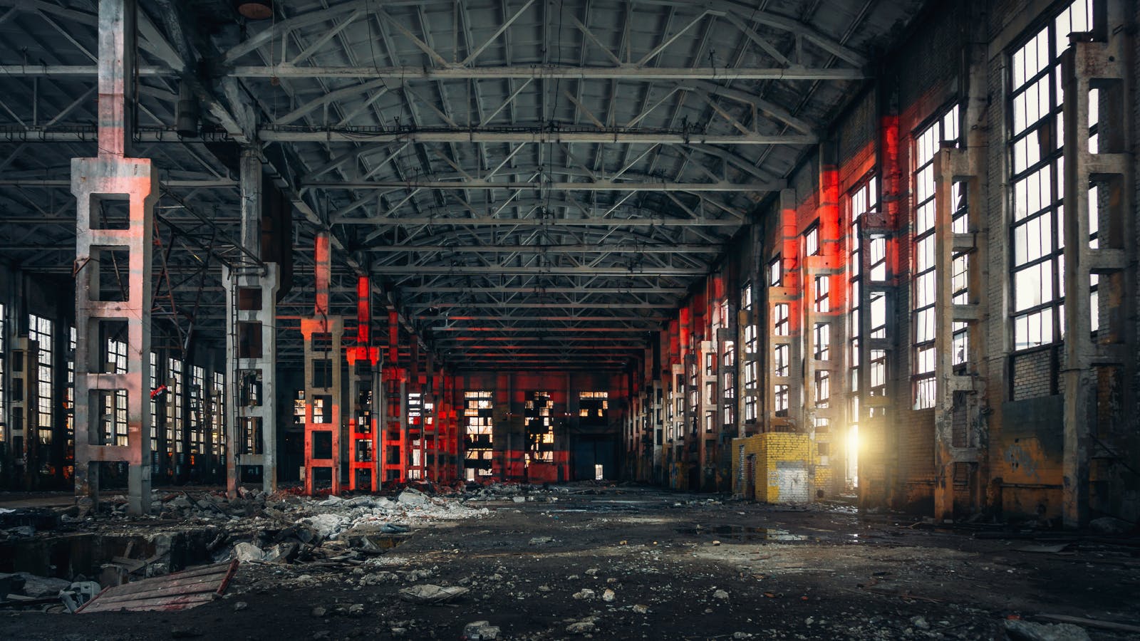 Interior of a large, abandoned warehouse or factory.